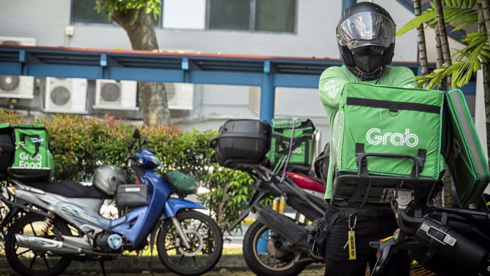Delivery rider using a motorcycle rental in Singapore during peak hours, representing delivery trends in Singapore in 2025